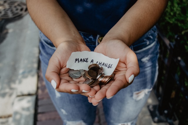 Person Holding Change in Hand