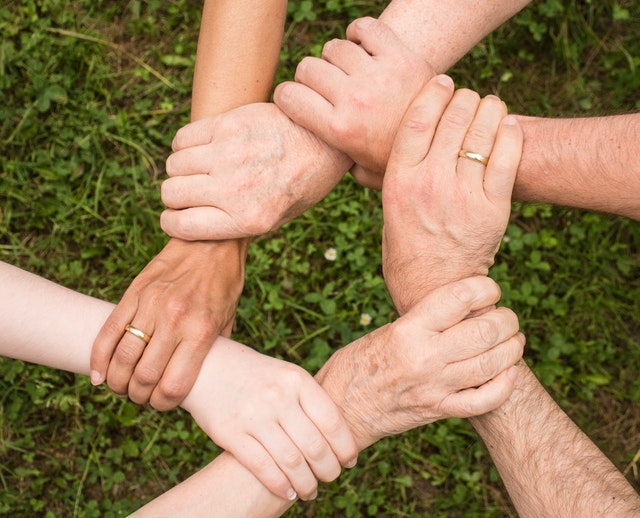 People Joining Hands Together